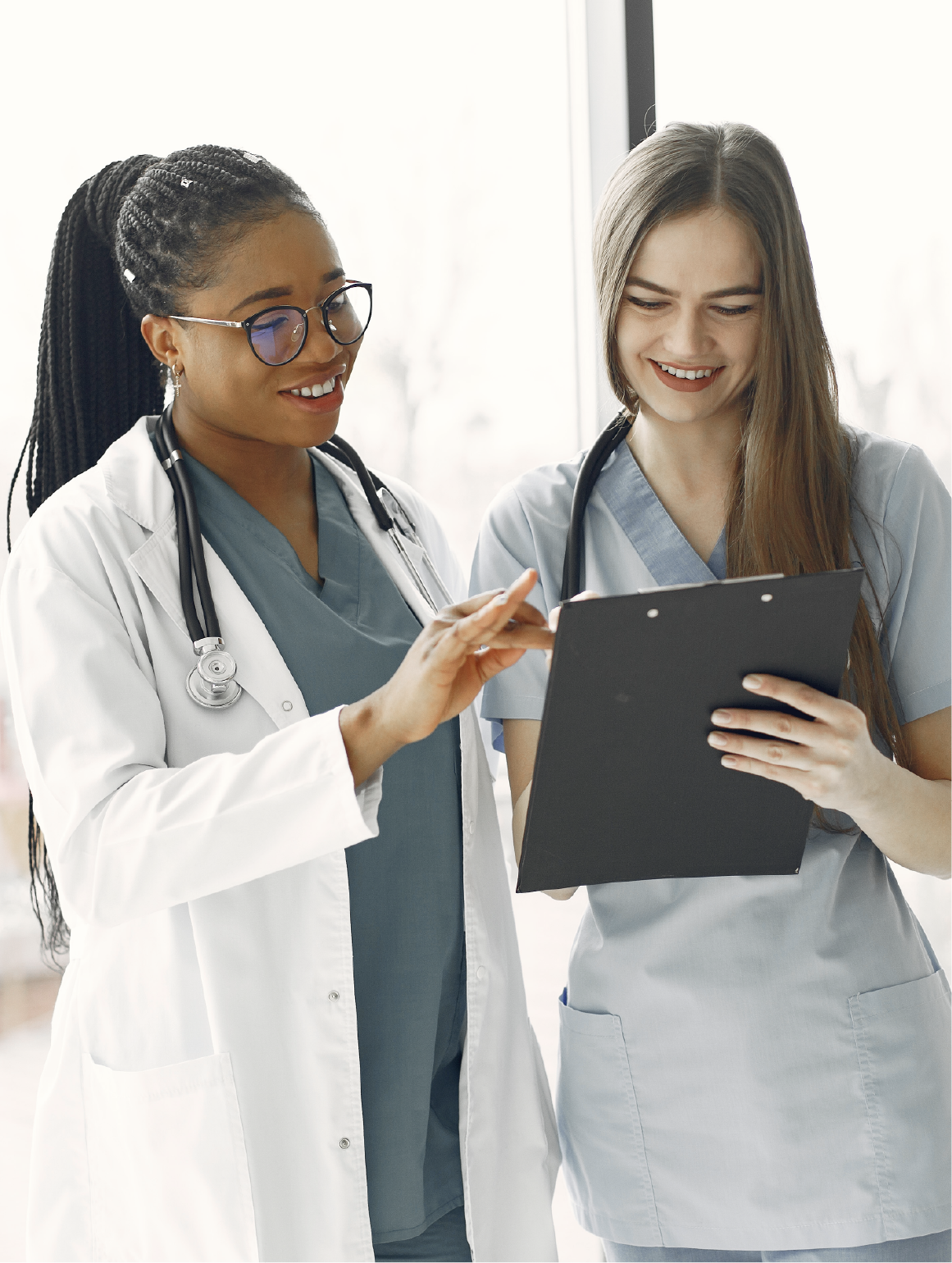 Doctor in white coat and stethoscope reviewing patient chart on clipboard with a nurse